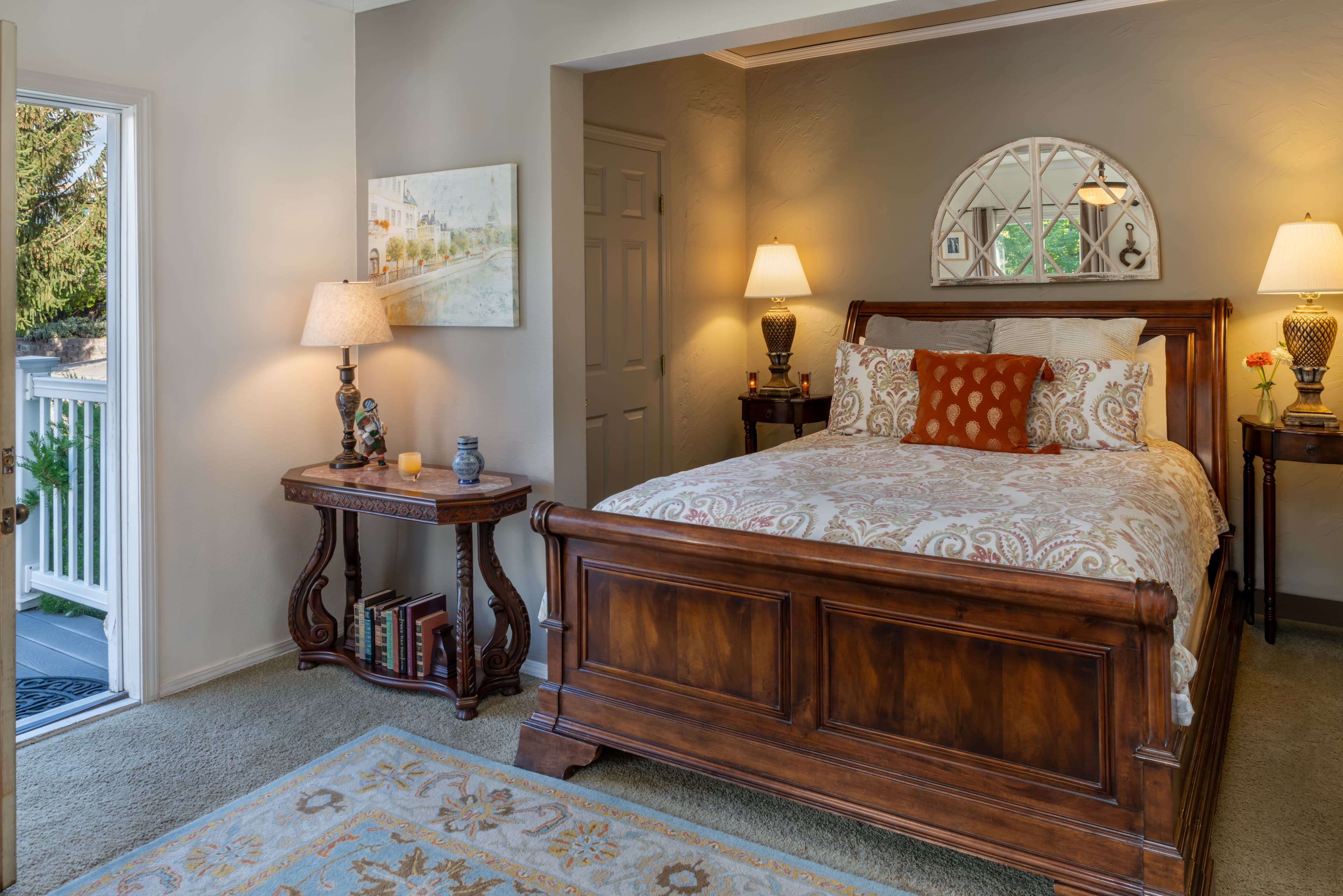 Orchard room with queen size bed tucked into sleeping nook, small living room area and private bath