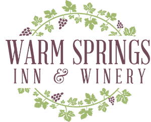 Logo for Warm Springs Inn & Winery featuring grapevine elements.