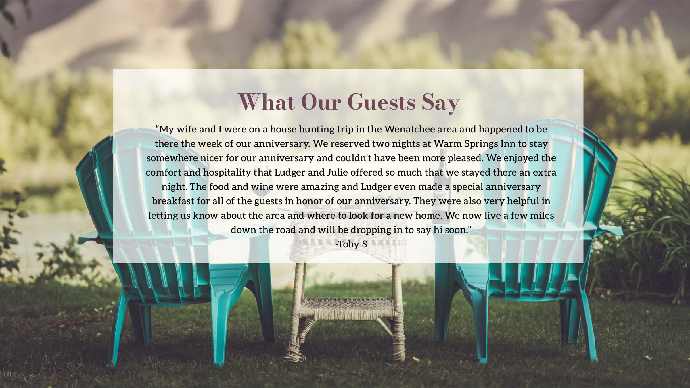 A tranquil outdoor view featuring two colorful chairs and a small table in a serene green setting.