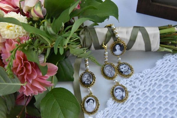 A bouquet of flowers accompanied by decorative pendants featuring black-and-white portraits.